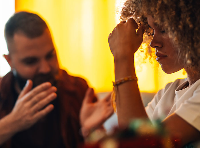 Frustrated woman and man arguing indoors, illustrating family drama and conflict after stealing grandson&rsquo;s ashes.