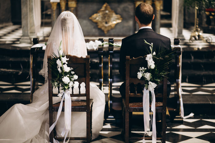 Bride and groom sitting on decorated chairs during a wedding ceremony, symbolizing multiple weddings attended by netizens. - 29