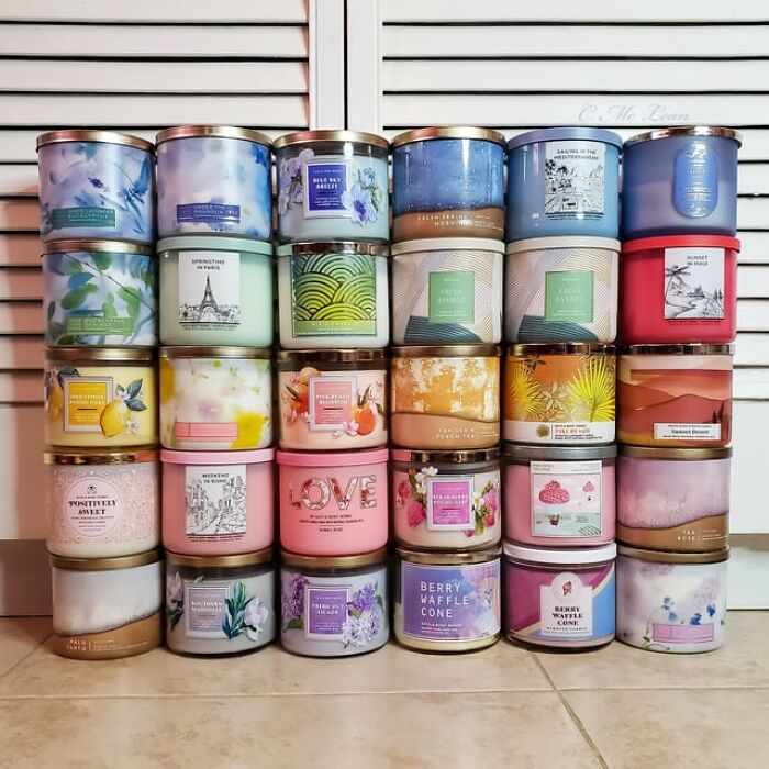 Stack of colorful scented candles representing trends in overconsumption leading to consumer fatigue and desire to stop buying. - 22