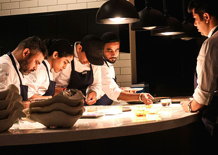 Team of chefs working together in a kitchen, illustrating creativity and strategy in powerful marketing campaigns.