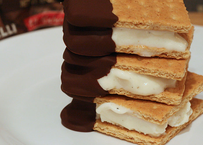 Close-up of stacked graham crackers with white filling and chocolate coating, illustrating powerful marketing campaigns concept.