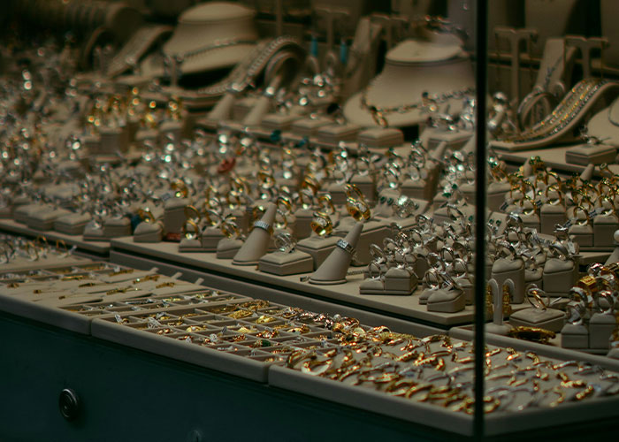 Display of various rings and jewelry in a store window showcasing marketing campaigns with powerful visual appeal.