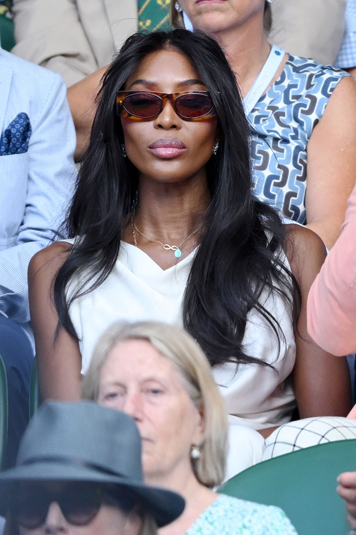 Naomi Campbell wearing sunglasses and a white outfit at Wimbledon 2025, showcasing celebrity fashion looks.