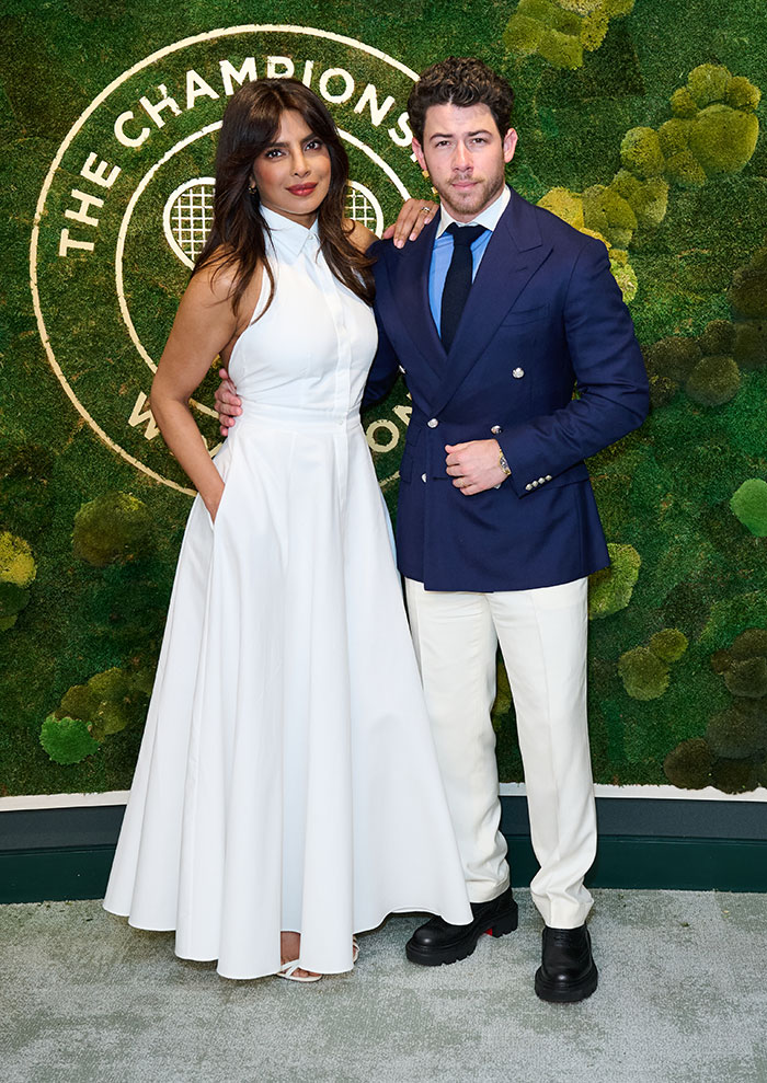 Priyanka Chopra in a white dress and Nick Jonas in a navy blazer and white pants showcasing Wimbledon 2025 celebrity looks.