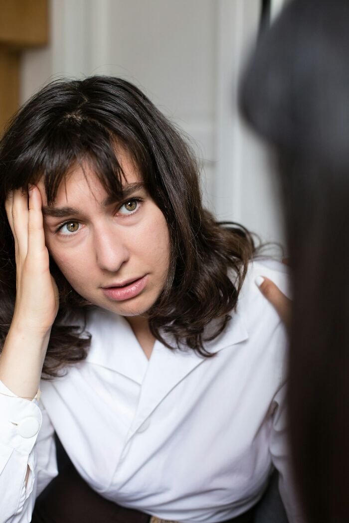 Young woman looking stressed and confused during a private investigator session about a weird case with many questions. - 12