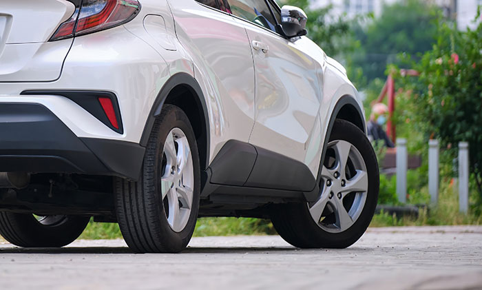White SUV parked on a driveway, illustrating a disabled woman&rsquo;s mistaken belief about owning the neighbor&rsquo;s driveway.