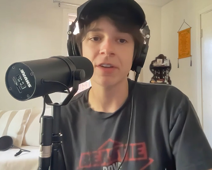 Person wearing headphones speaking into a microphone during a podcast discussing Olivia Rodrigo's caring gesture for her crew. Person wearing headphones speaking into a microphone during a podcast discussing Olivia Rodrigo's caring gesture for her crew.