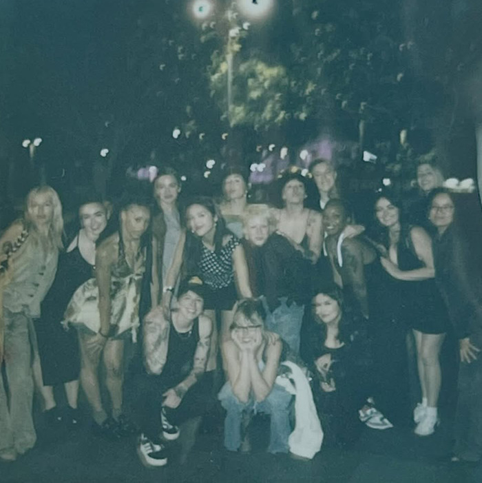 Olivia Rodrigo with her crew posing outdoors at night, capturing the moment behind her caring gesture for the team. Olivia Rodrigo with her crew posing outdoors at night, capturing the moment behind her caring gesture for the team.