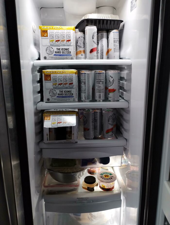 Open fridge filled mostly with hard seltzer cans and packs, illustrating a common roommate fridge scenario for Reddit tales.