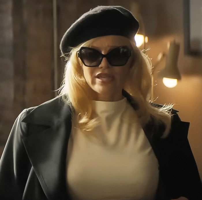 Pamela Anderson wearing a black beret and sunglasses on the latest red carpet event with Liam Neeson.