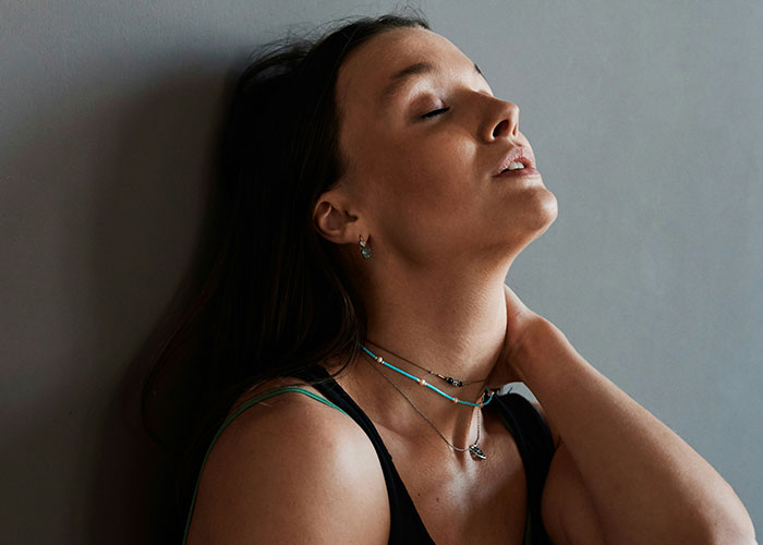 Woman looking stressed and contemplative, reflecting on feeling greedy after parents give sister &pound;160K but leave her struggling