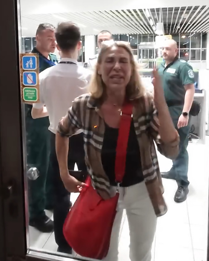 Woman having dramatic meltdown at airport after being denied boarding over luggage size by Ryanair staff. - 2
