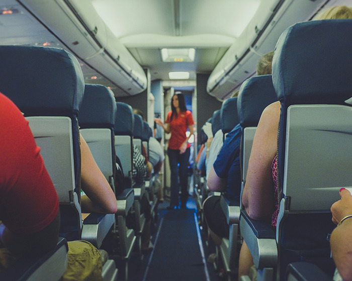Passengers sitting inside Japan Airlines flight cabin, experiencing sudden mid-air plunge while writing farewell messages. Passengers sitting inside Japan Airlines flight cabin, experiencing sudden mid-air plunge while writing farewell messages.