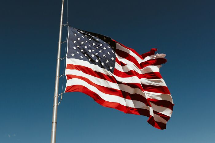 American flag waving on a flagpole against a clear blue sky, illustrating the theme of rare phobias. - 39