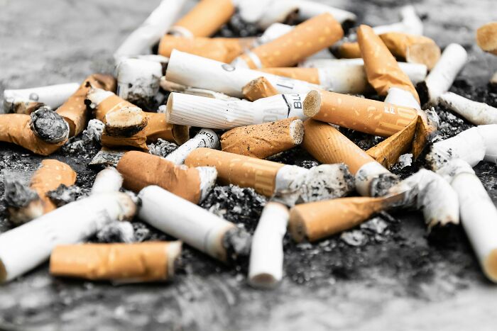 Pile of discarded cigarette butts on the ground illustrating things non-Americans do that make no sense to Americans. - 6