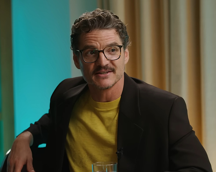 Pedro Pascal wearing glasses and a black blazer during a press tour interview sparking viral reactions. Pedro Pascal wearing glasses and a black blazer during a press tour interview sparking viral reactions.