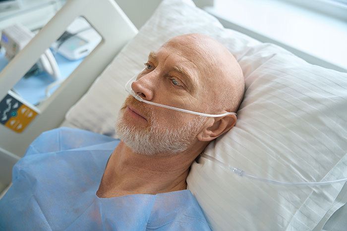 Elderly man in hospital bed with oxygen tube, showing resilience and determination after having enough and taking action. - 3