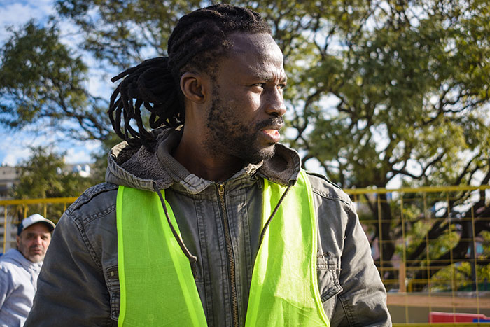 Man in a green safety vest looking determined outdoors, symbolizing times people had enough and took action. - 24