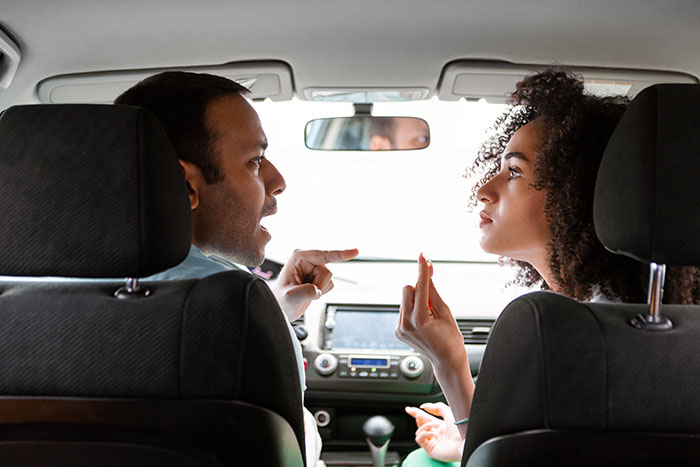 Man and woman arguing inside a car, showing people had enough and took action to resolve their conflict. - 20