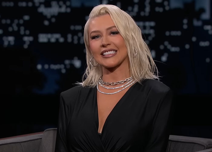 Blonde woman smiling during a TV interview, sharing insights from people who went to school with celebrities.