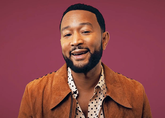 Man wearing a brown jacket and polka dot shirt smiling, related to people who went to school with celebrities sharing insights.
