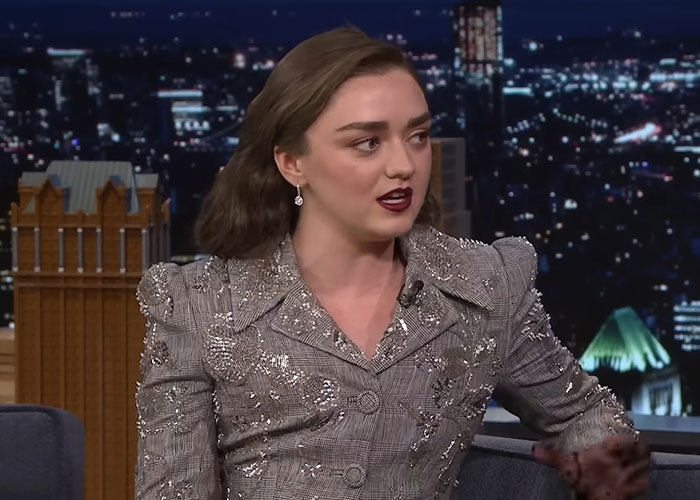 Actress wearing a patterned blazer sharing stories about school experiences with celebrities in a late night talk show interview.