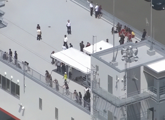 People gathered on ship deck as first tsunami waves hit Alaska following mega earthquake warnings.