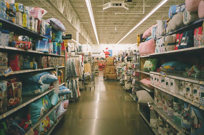 Store aisle with home goods, pillows, and bedding, illustrating secrets companies keep from their customers in retail settings - 22