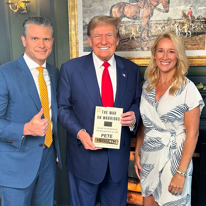 Pete Hegseth posing with two people including Donald Trump, holding his book, highlighting Pete Hegseth&rsquo;s net worth and public image.