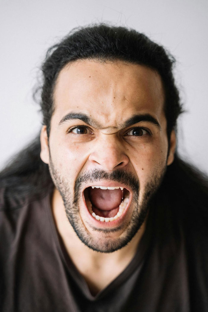 Man with long hair and beard showing anger, expressing frustration after reading wife’s diary behind her back. Man with long hair and beard showing anger, expressing frustration after reading wife’s diary behind her back.
