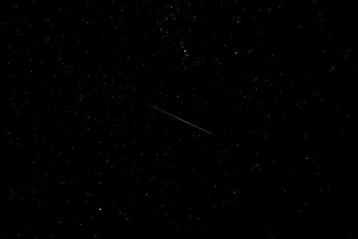 Night sky filled with stars and a faint shooting star, illustrating one of the most interesting mysteries that still baffle people.