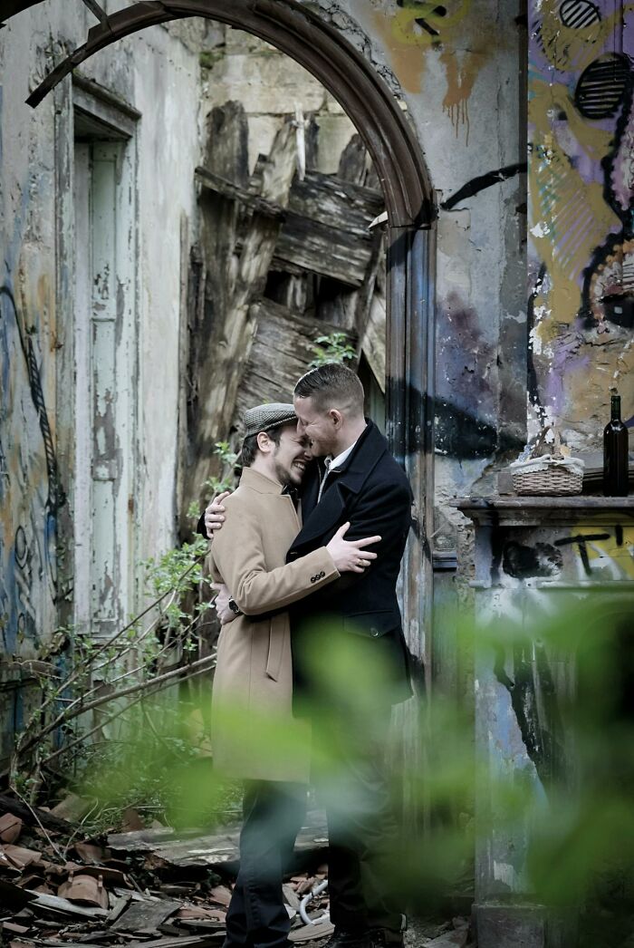 Two older men embracing and smiling in a rustic, abandoned building reflecting life after divorce. - 37