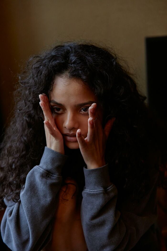 Young woman with curly hair looking distressed, symbolizing toxic friendships and emotional struggle with best friends. - 23