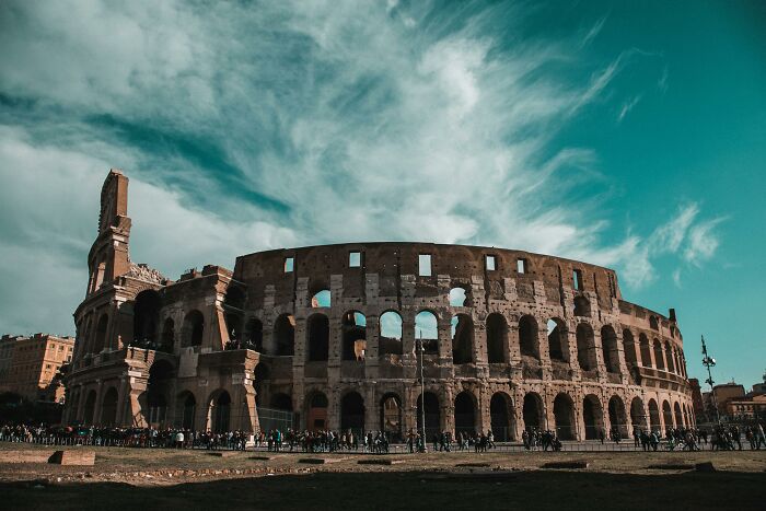 Ancient Roman Colosseum under a blue sky, representing one of the most interesting mysteries that still baffle people.