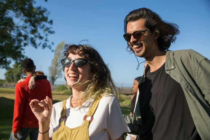 A group of young adults outdoors laughing and enjoying themselves, illustrating common toxic femininity behaviors. - 17