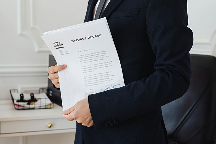Man in a suit holding a divorce decree document, symbolizing manipulative mom daughter story drama and family conflict. - 37