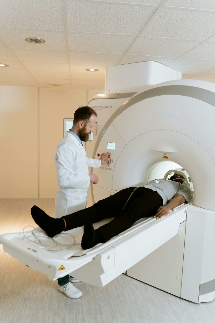 Radiology technician operating MRI machine while patient lies inside, showcasing high-paying healthcare job opportunities.