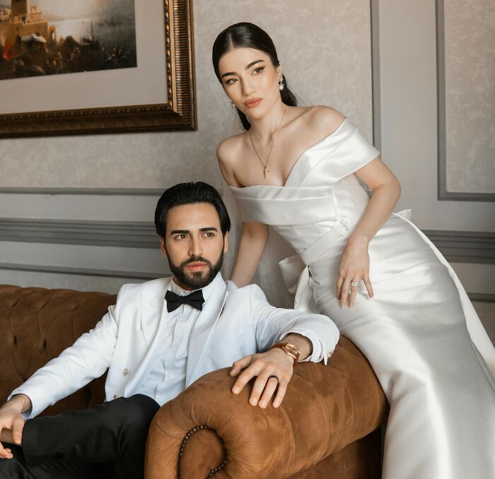 A well-dressed couple sharing moments on a couch, illustrating people share things improved life feelings and connections. - 31