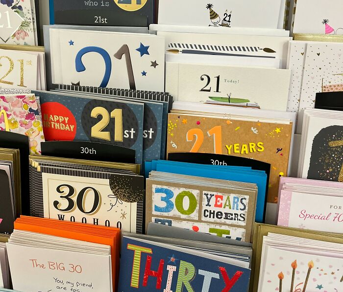 Greeting cards and thank you notes displayed on a store shelf, highlighting nostalgic paper communication items.