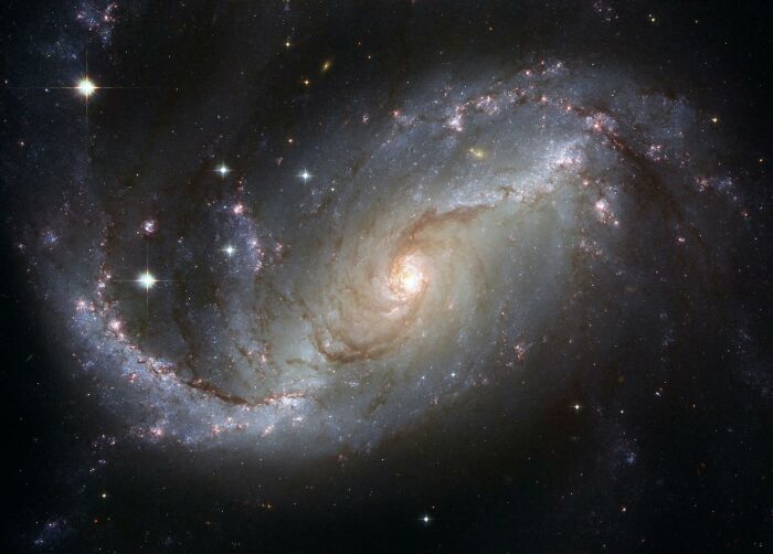 Spiral galaxy in deep space with glowing stars and cosmic clouds illustrating some of the most interesting mysteries.