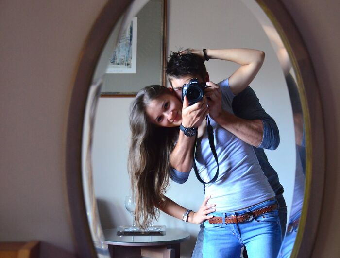 Couple taking a mirror selfie showing affectionate pose with potential cheating red flags in intimate relationship. - 5