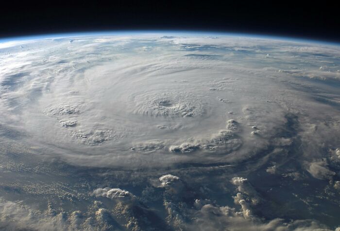Massive swirling storm system over Earth’s atmosphere, illustrating crazy but real historical weather events from space.