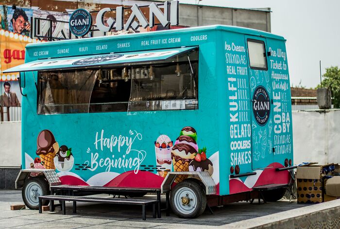 Ice cream truck with colorful designs offering kulfi, gelato, and shakes, evoking harmless lies parents told that left trauma. - 3
