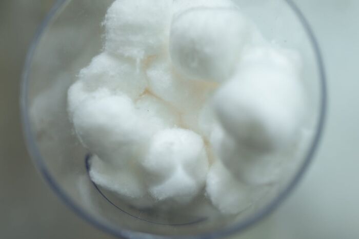 Close-up of white cotton balls in a transparent container representing rare phobias related to common objects and textures. - 29