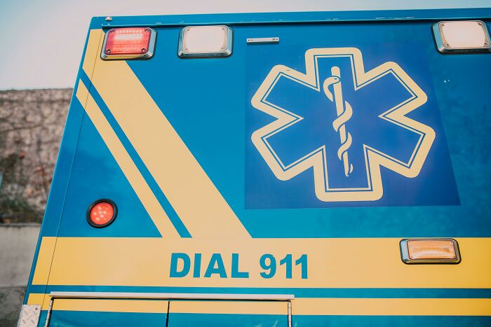 Close-up of ambulance emergency symbols and dial 911 sign related to doctors meeting impostor patients stories.