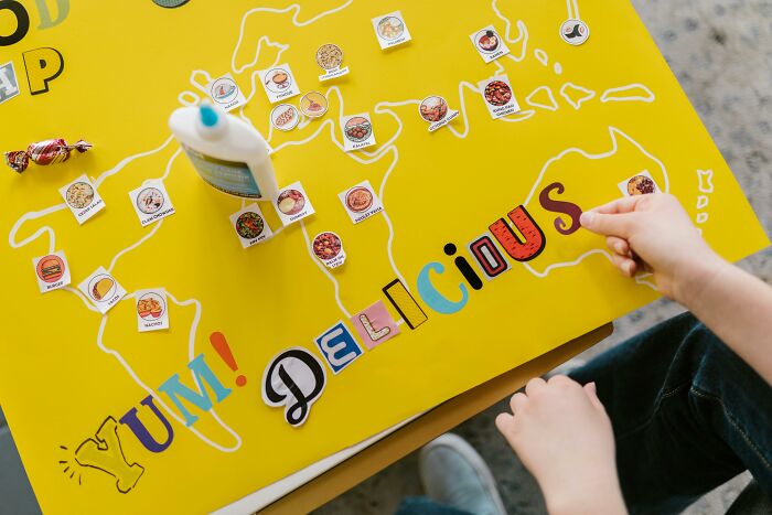 Child arranging food icons on a colorful map highlighting the global food waste crisis and its trillion-dollar problem.