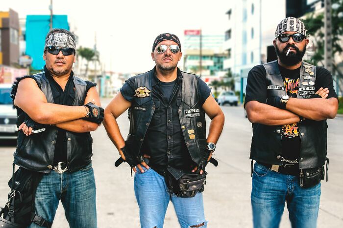 Three men in biker vests and bandanas standing on a city street, evoking a vintage feel tied to thank you notes nostalgia.