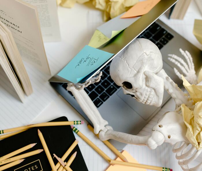 Skeleton figure at laptop surrounded by pencils and notes illustrating creepy habits of normal people online. - 18