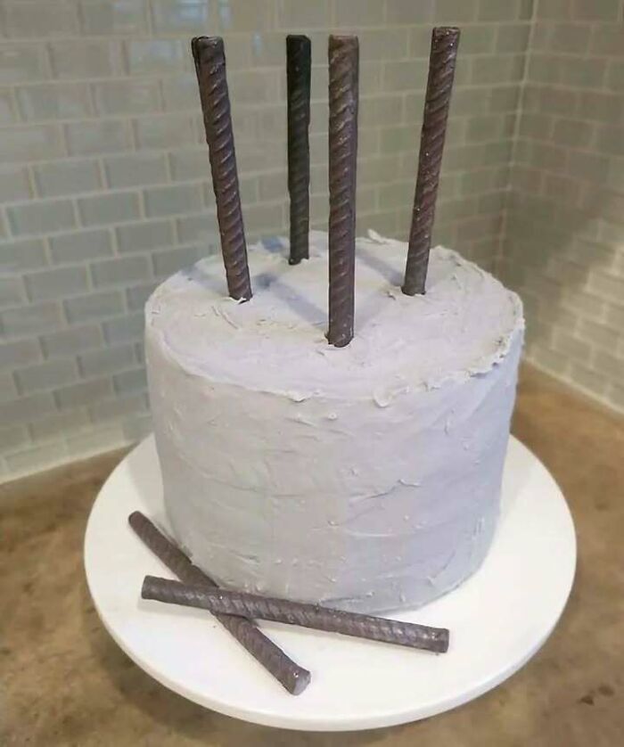 Cake decorated with metal rods resembling construction rebar, combining trash and culture in a chaotic and humorous way.