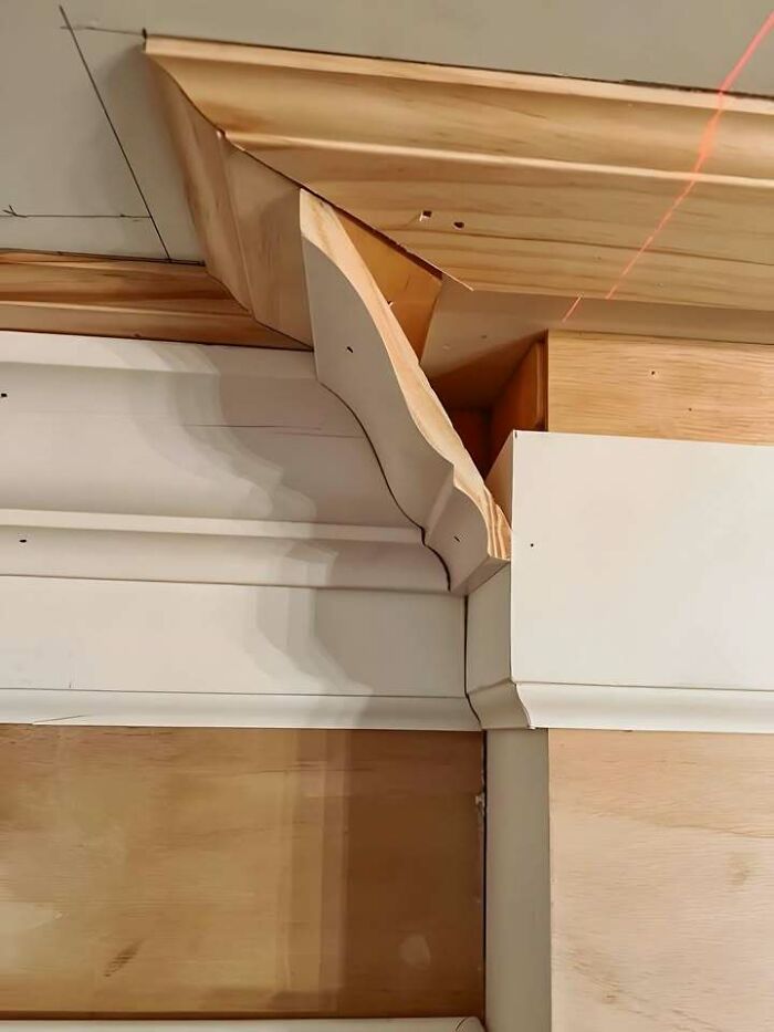 Incorrectly installed wooden trim showing a hilariously dumb mistake despite engineering degrees and construction effort.
